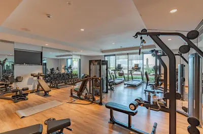 a gym with a lot of treadmills and machines at BLVD - Steps from Dubai mall and Dancing Fountain in Dubai