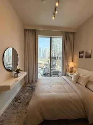 a bedroom with a large bed and a large window at Upgraded brand new apartment Downtown in Dubai