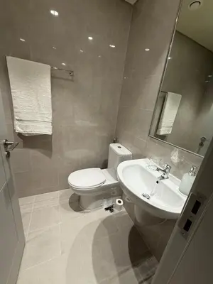 a bathroom with a toilet and a sink at Upgraded brand new apartment Downtown in Dubai