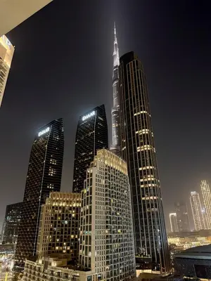 a group of tall buildings in a city at night at Upgraded brand new apartment Downtown in Dubai
