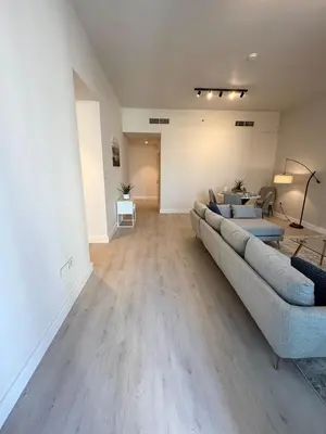 a living room with a couch and a table at Upgraded brand new apartment Downtown in Dubai