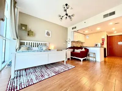 a living room with a bed and a living room at Studio apartment in jumeriah village triangle district 2 in Dubai