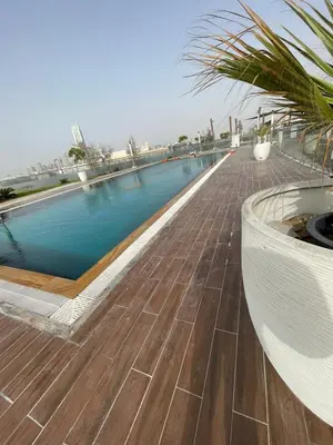 a swimming pool on the roof of a building at Studio apartment in jumeriah village triangle district 2 in Dubai