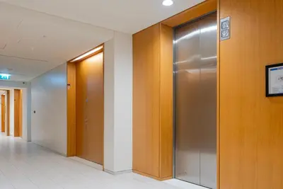a hallway with elevator doors in a building at Stunning Burj Khalifa & Downtown Views - Elegant 1BR in The Iconic Index Tower in Dubai