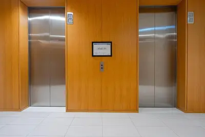 a row of elevator doors in a building at Stunning Burj Khalifa & Downtown Views - Elegant 1BR in The Iconic Index Tower in Dubai