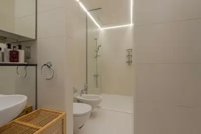 a white bathroom with a sink and a toilet at Stunning Burj Khalifa & Downtown Views - Elegant 1BR in The Iconic Index Tower in Dubai