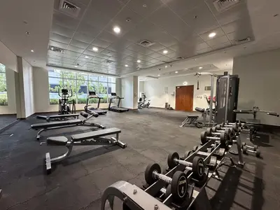 a gym with a bunch of treadmills and machines at Elegant 1BR in Dunya Tower, Downtown Dubai 12AB10 in Dubai