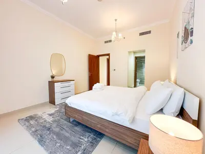 a bedroom with a bed and a sink and a mirror at Elegant 1BR in Dunya Tower, Downtown Dubai 12AB10 in Dubai