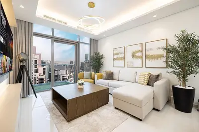 a living room with a couch and a table at 5Star Stunning 2BR BURJ Khalifa View with Infinity Pool in Dubai