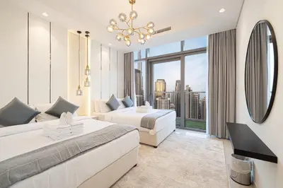 a hotel room with two beds and a large window at 5Star Stunning 2BR BURJ Khalifa View with Infinity Pool in Dubai