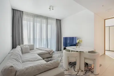 a living room with a couch and a table at Luxury Escape w Stunning Views Address JBR 1BR in Dubai