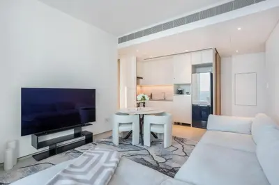 a living room with a white couch and a table at Luxury Escape w Stunning Views Address JBR 1BR in Dubai