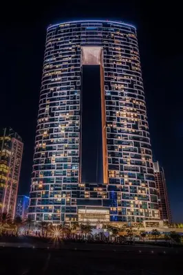 a tall building with lights on it at night at Luxury Escape w Stunning Views Address JBR 1BR in Dubai