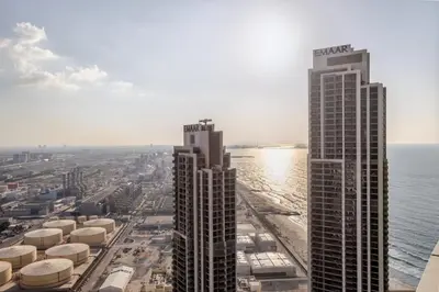 two tall buildings next to a body of water at Luxury Escape w Stunning Views Address JBR 1BR in Dubai