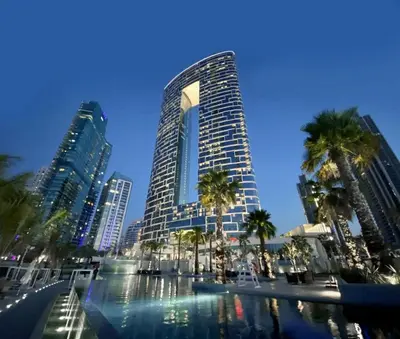 a tall building with palm trees in front of it at Luxury Escape w Stunning Views Address JBR 1BR in Dubai
