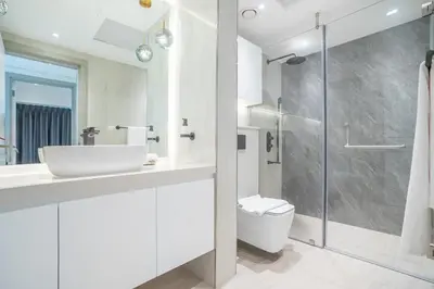 a bathroom with a sink and a toilet and a shower at RH -Luxury 1BR, Large Balcony & High-End Interiors, Downtown in Dubai