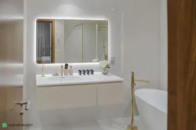 a bathroom with a sink and a mirror and a tub at Clever Guest 028 Baltic in Dubai