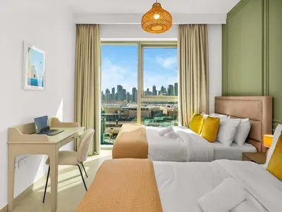a bedroom with a bed and a desk and a window at Amazing view Burj Khalifa 5mn Dubai Mall 2BDR in Dubai