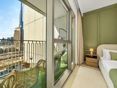a room with a bed and a balcony with a view at Amazing view Burj Khalifa 5mn Dubai Mall 2BDR in Dubai