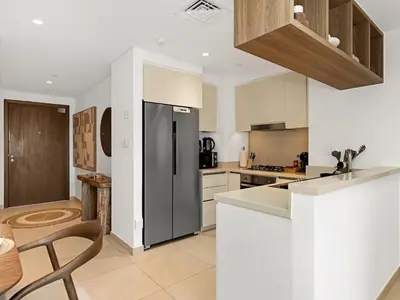 a kitchen with a stainless steel refrigerator and white cabinets at Amazing view Burj Khalifa 5mn Dubai Mall 2BDR in Dubai