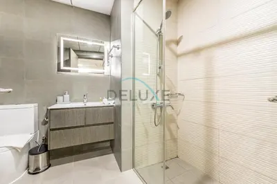a bathroom with a shower and a sink and a toilet at Peaceful 1BR in Bella Rose Al Barsha South by Deluxe Holiday Homes in Dubai