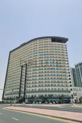 a large building with a lot of windows at Peaceful 1BR in Bella Rose Al Barsha South by Deluxe Holiday Homes in Dubai