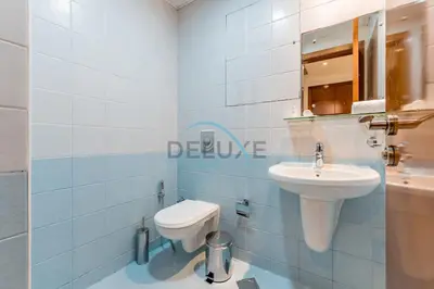 a bathroom with a white toilet and a sink at Stunning 2BR with Assistant Room in MAG 214, Jumeirah Lake Towers by Deluxe Holiday Homes in Dubai