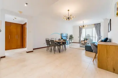 a living room with a couch and a table at Stunning 2BR with Assistant Room in MAG 214, Jumeirah Lake Towers by Deluxe Holiday Homes in Dubai