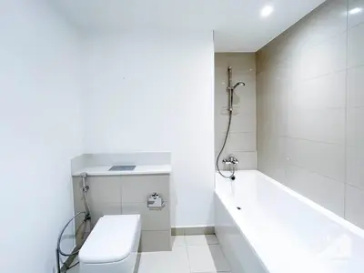 a white bathroom with a tub and a toilet at Luxury Design & Stunning Views in Dubai Hills in Dubai