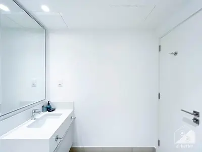 a bathroom with a white sink and a mirror at Luxury Design & Stunning Views in Dubai Hills in Dubai
