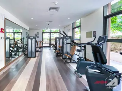 a gym with treadmills and cardio equipment in a room at Luxury Design & Stunning Views in Dubai Hills in Dubai