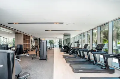 a gym with a row of treadmills and exercise bikes at Luxury 1-Bedroom Holiday Apartment in Downtown Dubai I Walk to Dubai Mall and Fountains in Dubai