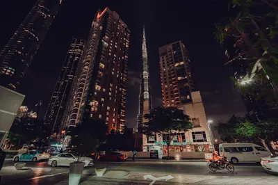 a city at night with tall buildings and cars at Elegant Studio Downtown 5 Minute Walk to Burj Khalifa & Dubai Mall in Dubai