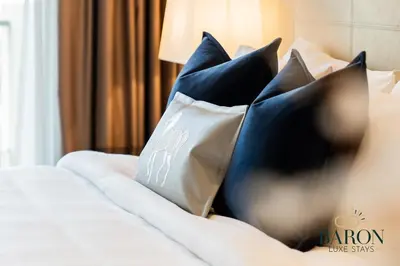 a bed with blue and white pillows on it at The Classic in Dubai