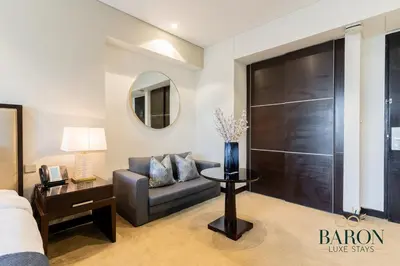 a living room with a couch and a table at The Classic in Dubai