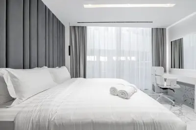 a bedroom with a large bed with two towels on it at Grand Dubai Marina 4BR Triplex with Pool Gym Sauna in Dubai