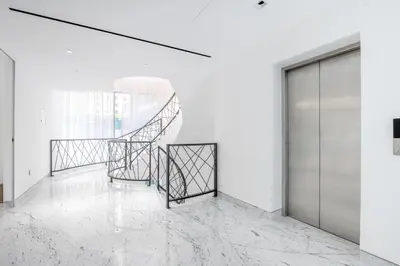 a room with white walls and white marble floors at Grand Dubai Marina 4BR Triplex with Pool Gym Sauna in Dubai