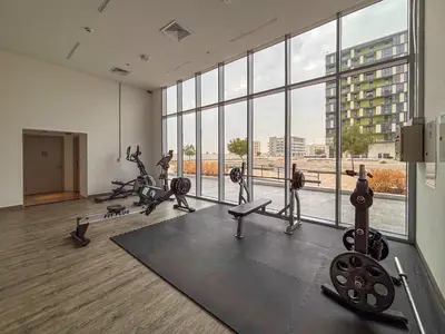 a gym with tread machines and a large window at Frank Porter - Pulse C1 in Dubai