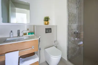 a bathroom with a toilet and a sink and a shower at Frank Porter - Golf Vile in Dubai