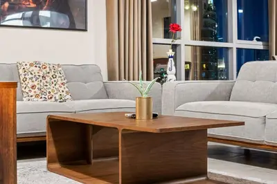 a living room with a couch and a coffee table at FIRST CLASS 2BR Burj Khalifa & Fountain View in Dubai
