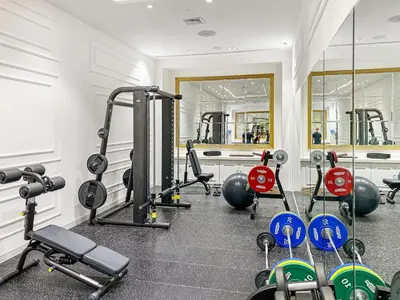 a gym with a bunch of equipment in a room at FIRST CLASS 2BR Burj Khalifa & Fountain View in Dubai