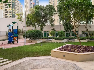 a park with a playground in a city at FIRST CLASS 2BR Burj Khalifa & Fountain View in Dubai