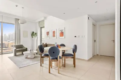 a dining room with a table and chairs at Silkhaus Deluxe 2BR in Downtown Views II in Dubai