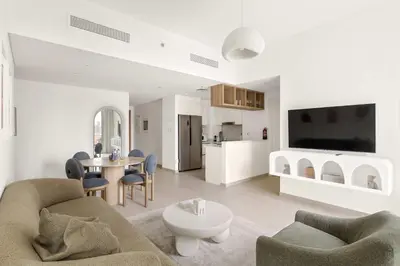 a living room with a couch and a table at Silkhaus Deluxe 2BR in Downtown Views II in Dubai