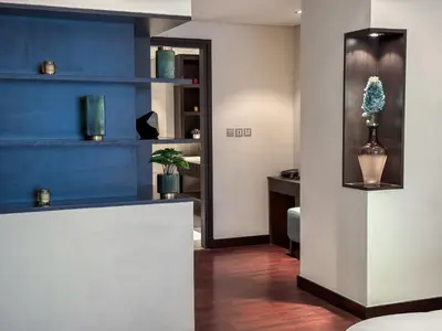 a room with blue walls and a counter with a vase at Picture-Perfect 2BR apartment with Burj View in Dubai