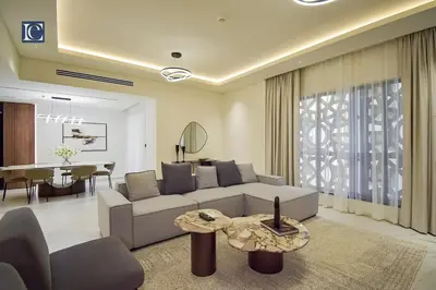 a living room with a couch and a table at Luxury Escapes - Elegant 3 Bedroom plus Maids Room Apartment in JBR in Dubai