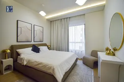 a bedroom with a bed and a mirror and a couch at Luxury Escapes - Elegant 3 Bedroom plus Maids Room Apartment in JBR in Dubai