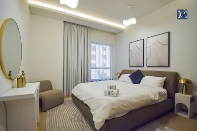 a bedroom with a large bed and a mirror at Luxury Escapes - Elegant 3 Bedroom plus Maids Room Apartment in JBR in Dubai