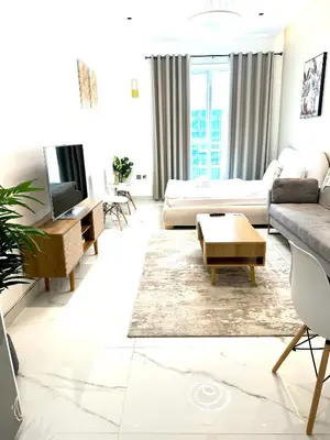 a living room with a couch and a table at Stunning Studio with Sea-View in Jumeirah Lake Towers JLT in Dubai