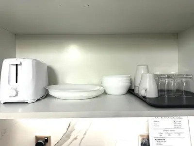 a shelf with bowls and other kitchen items on it at Stunning Studio with Sea-View in Jumeirah Lake Towers JLT in Dubai